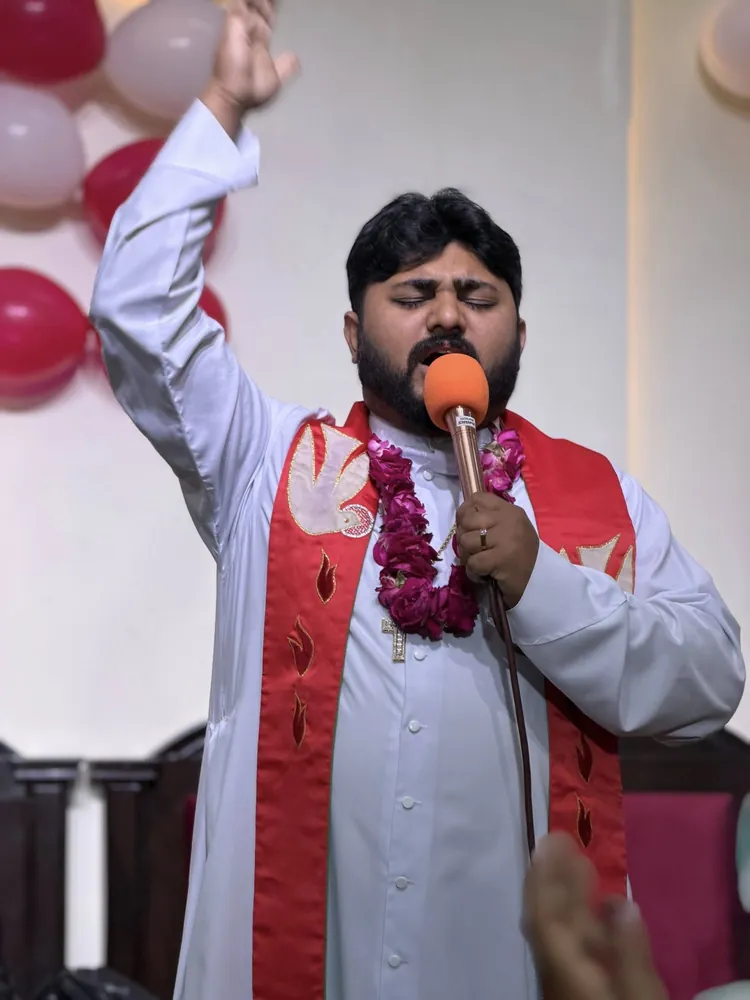 The pastor preaching in red vestments on Easter Sunday