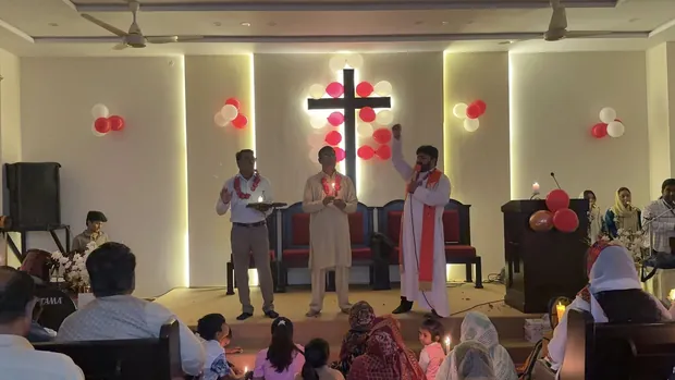 The cross on the church stage, dressed for Resurrection Sunday
