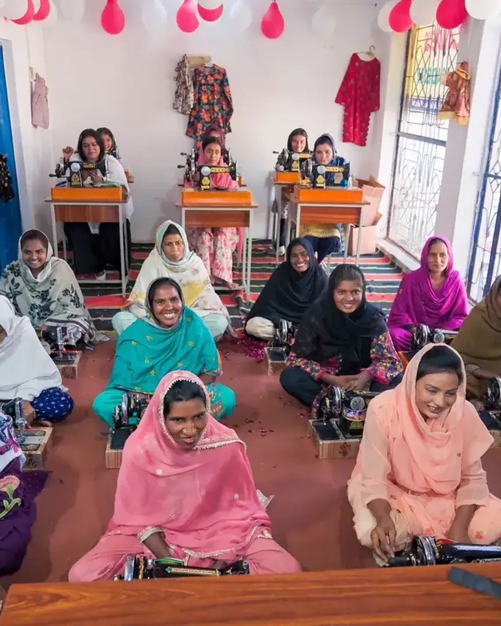 A room of women at their sewing machines in a Harvest Hands sewing centre
