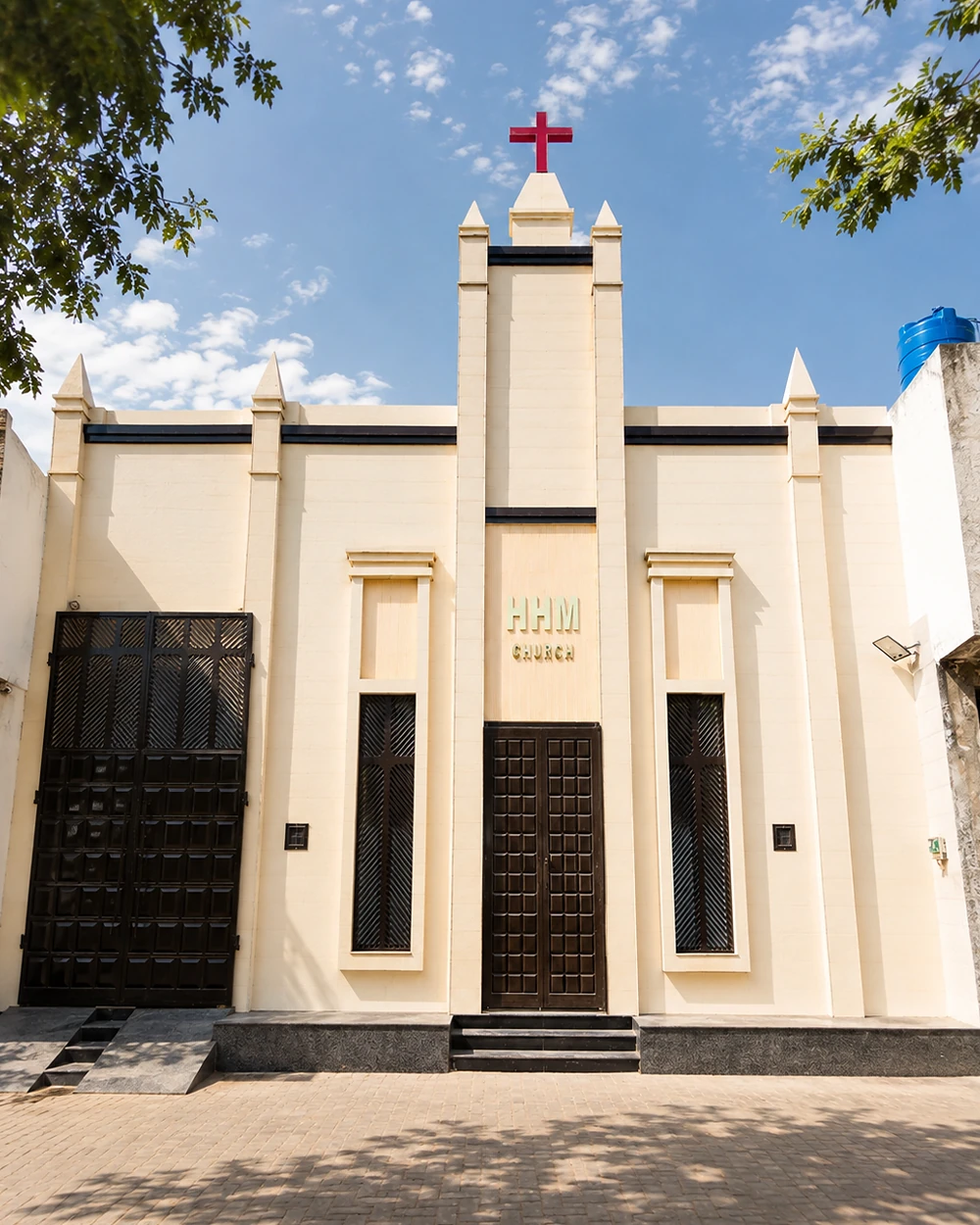 The finished Harvest Hands Church in Faisalabad, its cross raised above the street