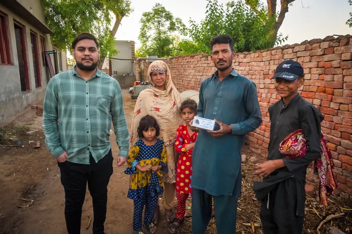 A family receiving their audio Bible together
