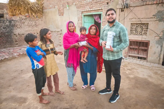 A mother and her children with their new player