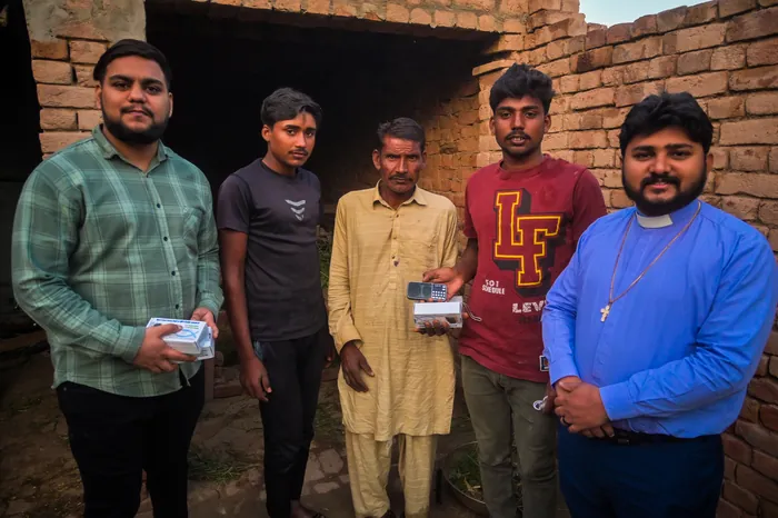 The pastor delivering audio Bibles in the village