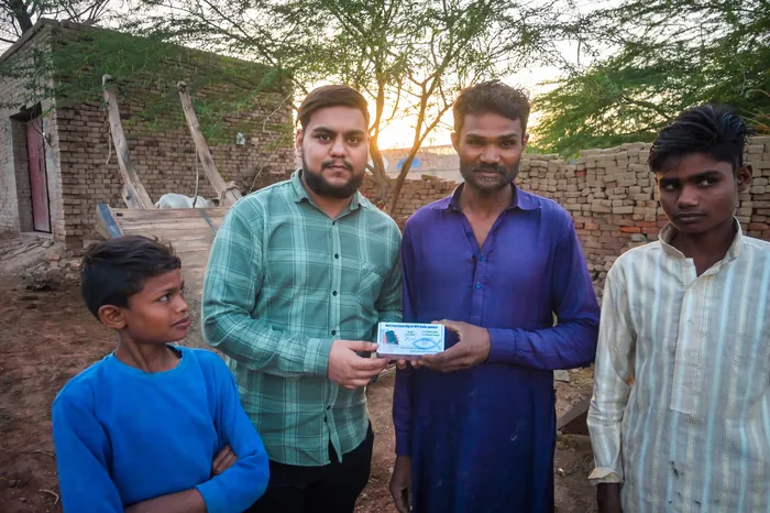Handing over an audio Bible as the sun goes down