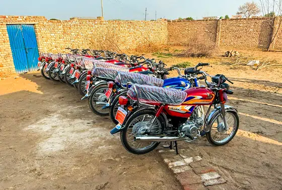 A pastor receiving a motorbike from Harvest Hands Ministries