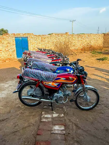 A pastor with the motorbike he was given