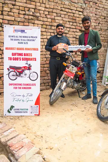 A pastor with the motorbike he was given
