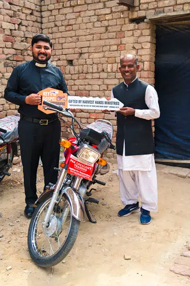 A pastor with the motorbike he was given