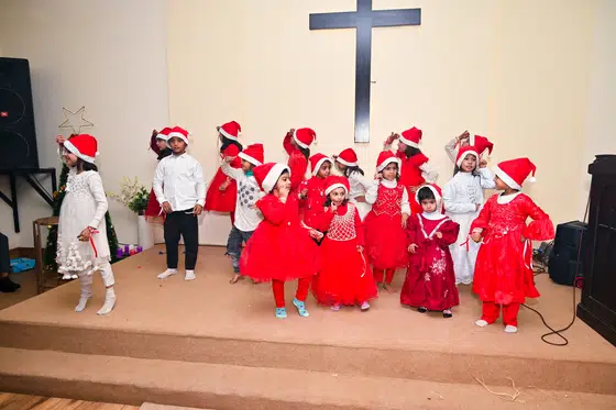 Children in Santa hats at the Christmas programme