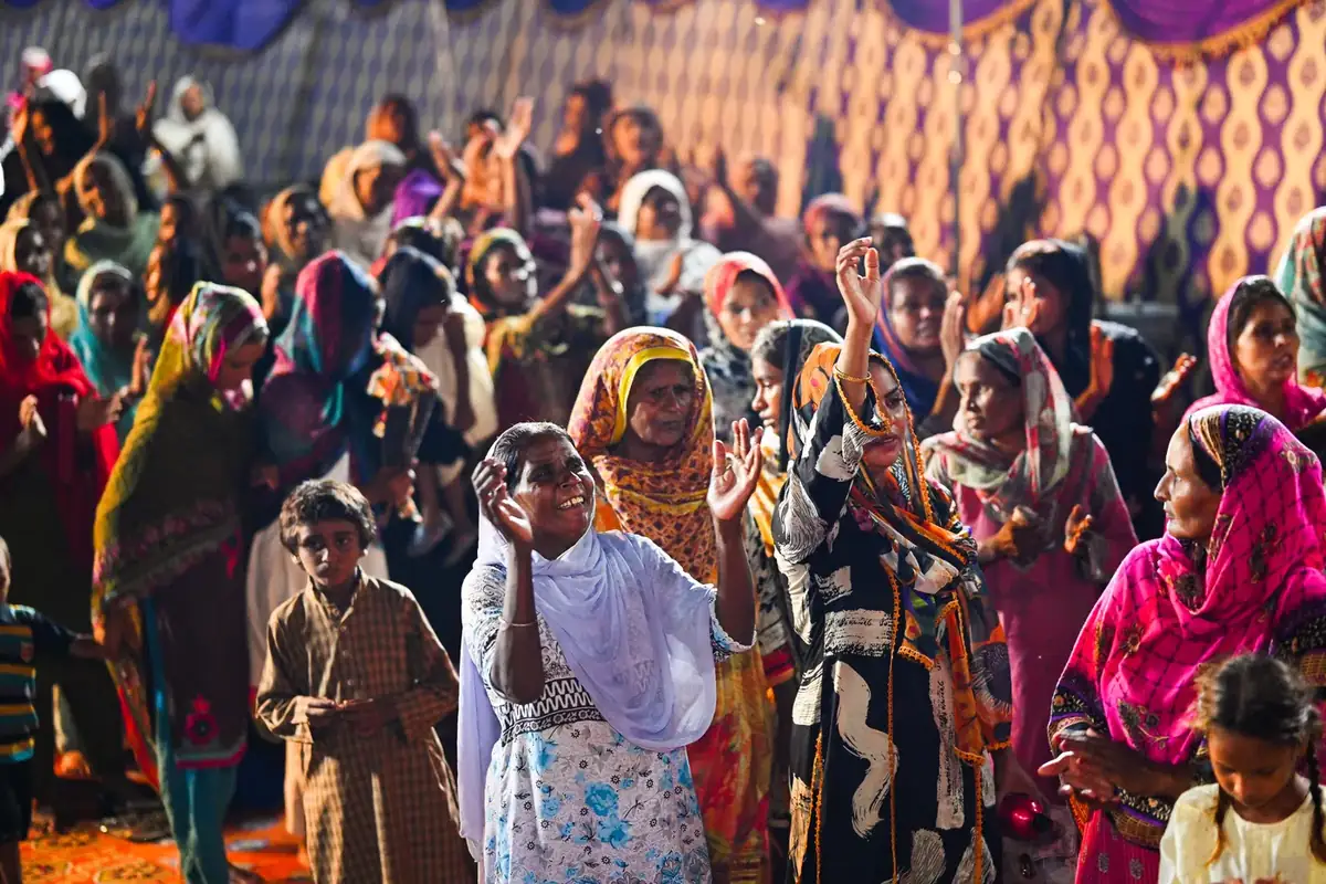 Women gathered at an open-air meeting